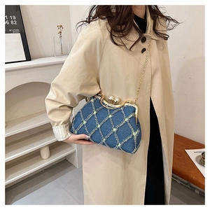 Blue denim shell bag with diamond stitching, pearl clasp, and gold chain strap detail
