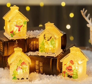 Close-up of glowing LED Christmas house decor with Santa and snowman scenes