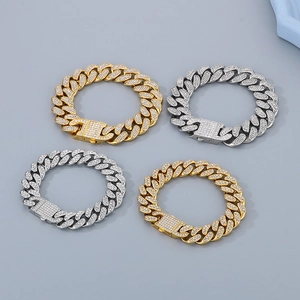 Set of four iced out Cuban link bracelets in gold and silver finish with rhinestones