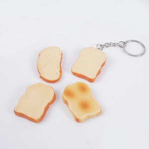 Set of four realistic mini PVC toast bread models with metal keychain on white background