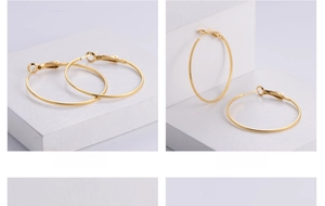 Macro detail of 18k gold plated hoop earrings with textured diamond-cut pattern surface
