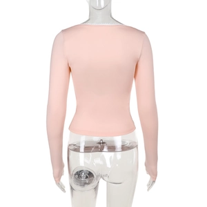 Detail of pink long sleeve top with square neck lace trim and slim fit back design