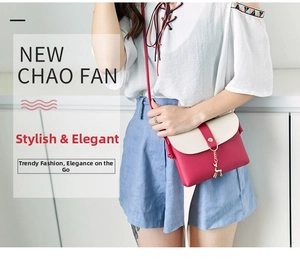 Close-up of contrast color crossbody bag with gold deer pendant on model side profile