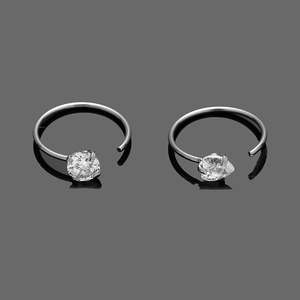 Detailed macro view of silver 316L stainless steel hoop earrings with clear cubic zirconia