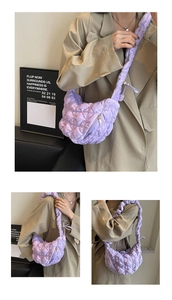 Purple quilted cloud shoulder bag with velvet texture shown on model in modern interior