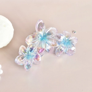 Detail of a transparent iridescent flower hair claw clip with colorful laser finish