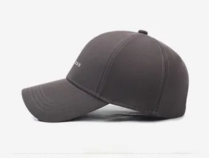 Detail view of dark grey baseball cap with white son embroidery and decorative stitching