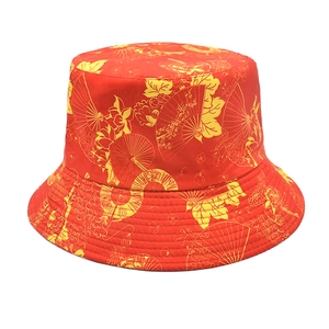 Detail of red bucket hat featuring yellow Chinese floral patterns and fan embroidery