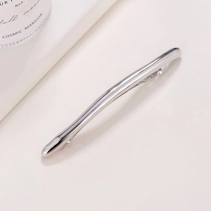 Sleek silver minimalist metal hair clip with a streamlined long bow design