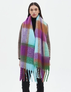 Detailed view of oversized colorful plaid scarf with soft fringes in purple and green
