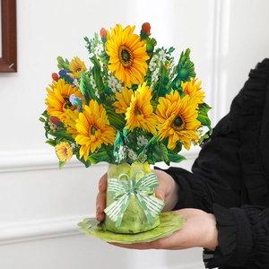 Close-up of 3D pop-up greeting card featuring a sunflower bouquet in a green paper vase