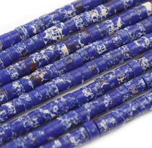 Detailed macro view of flat blue and white marbled stone spacer beads for DIY jewelry