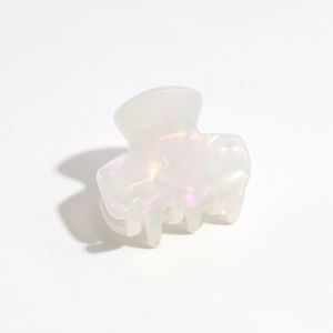 Macro detail of pearlescent leopard gradient hair claw clip with holographic resin texture