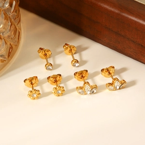 Close-up of gold stainless steel stud earring set with zircon flowers and round stones