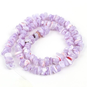 Macro view of purple irregular shell beads with natural textures for DIY jewelry crafting