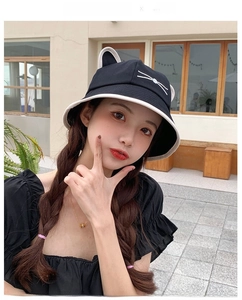 Detail of black cat ear bucket hat featuring white whiskers embroidery and contrast piping