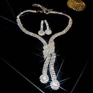 Sparkling crystal bow jewelry set with necklace and earrings on a black background