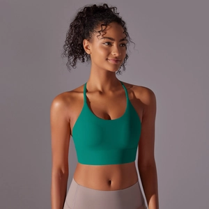 Close-up of deep green sports bra with wide elastic band and criss-cross back detail