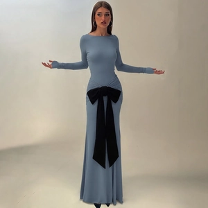 Detail of grey-blue long-sleeve dress with a large black bow and pleated waist