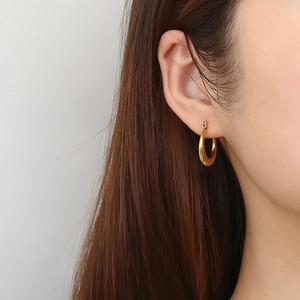 Minimalist gold hoop earrings for women featuring a clean geometric circular design