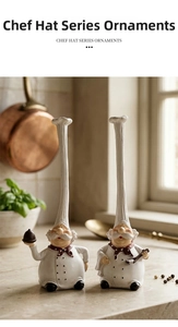 Macro detail of resin chef figurines with tall white hats and red polka dot scarves