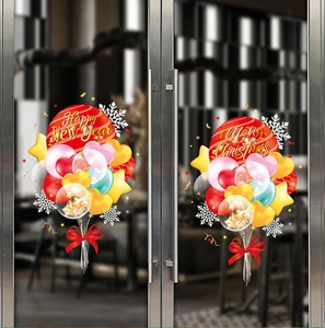 Detail of Christmas window stickers with festive red balloons, snowflakes and holiday greetings