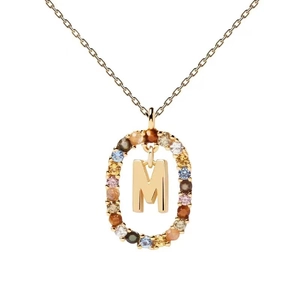 Detail of gold letter M pendant surrounded by colorful cubic zirconia on a gold chain
