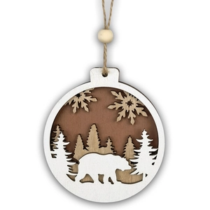 Detailed multi-layered wooden Christmas ornament with a white bear and forest scene