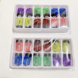 Macro shot of 24 colorful mini LED flashlight keychains in white blister tray packaging