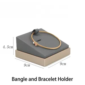 Detailed view of a grey velvet jewelry display tray with dimensions 9cm x 9cm x 4.5cm
