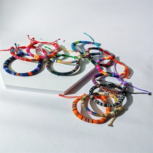 Close-up of handmade bohemian woven surfing bracelets with colorful ethnic patterns