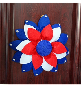 Detailed macro view of American flag fabric flower wreath on a dark wooden door