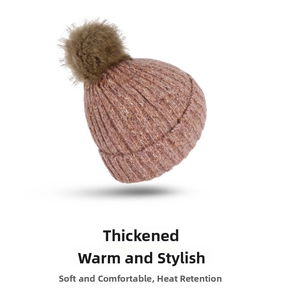 Close-up of pink knit winter beanie featuring a thick texture and soft faux fur pompom