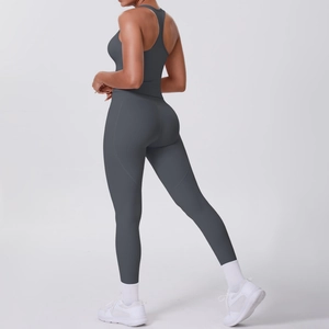 Detailed back view of charcoal grey racerback sports bra and high-waisted yoga leggings