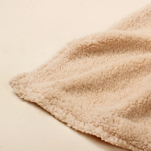 Close-up of thick off-white sherpa fleece fabric showing soft curly texture and plush material