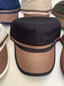 Detail of cadet caps featuring canvas bodies with textured leather brims and star patterns