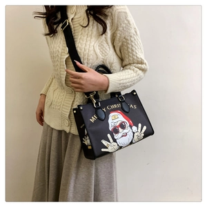 Detailed close-up of Christmas tote bag with cartoon Santa print on black fabric