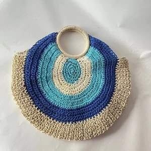 Summer circular straw handbag with multi-color concentric weave and integrated handles