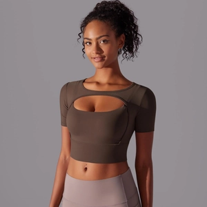 Close-up of deep brown mesh-spliced sports crop top with cutout design and matte finish