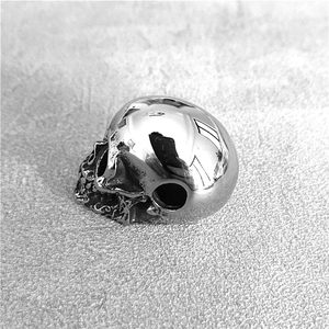 Close-up of a polished silver skull pendant made of durable stainless steel