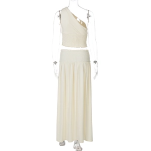 Front view of cream one-shoulder crop top and high-waist pleated maxi skirt set on mannequin