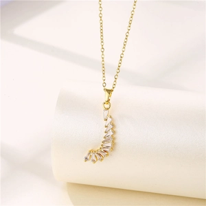 Detailed close-up of golden crescent moon pendant with rectangular zircon stones