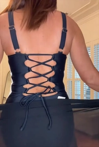 Detail of one-piece swimsuit featuring an elegant criss-cross back and metal ring detail