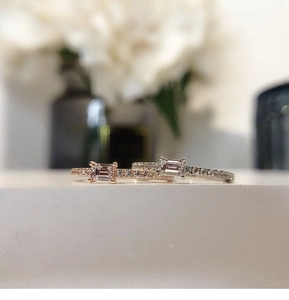 Detail of silver and rose gold stackable rings with rectangle cut sparkling cubic zirconia