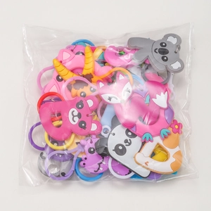 A collection of colorful PVC animal alphabet keychains packed in a clear bag for parties