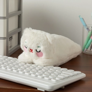 Close-up of fluffy white plush pencil case with cute cat embroidery on a desk