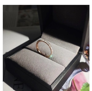 Close-up of rose gold starburst ring with cubic zirconia in a grey velvet box