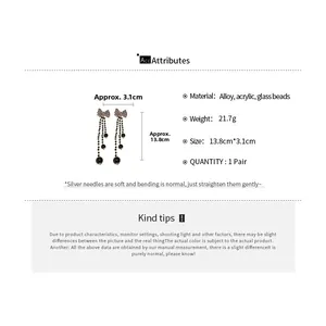 Detail view of bow knot long tassel earrings with dimensions 13.8cm and 3.1cm