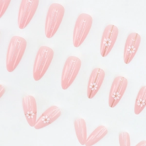 Elegant almond press-on nails in soft pink with golden lines and white daisy patterns