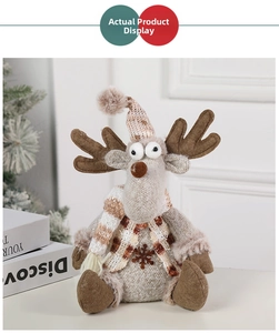 Close-up of reindeer plush toy featuring red checkered scarf and snowflake embroidery